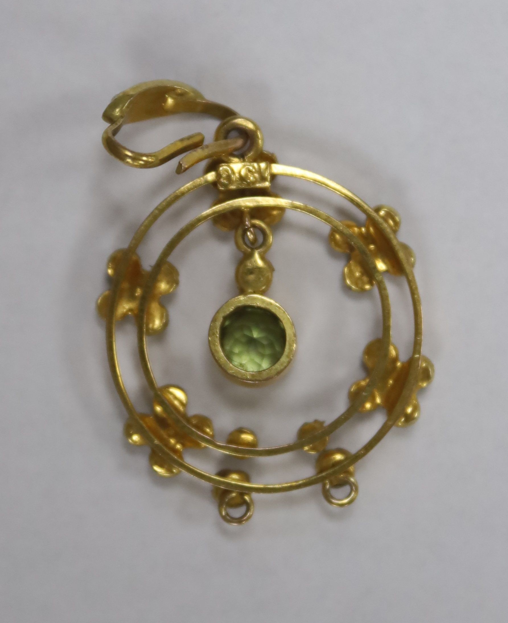 An early 20th century 9ct, peridot and seed pearl set drop pendant, overall 35mm, gross weight 2.1 grams.